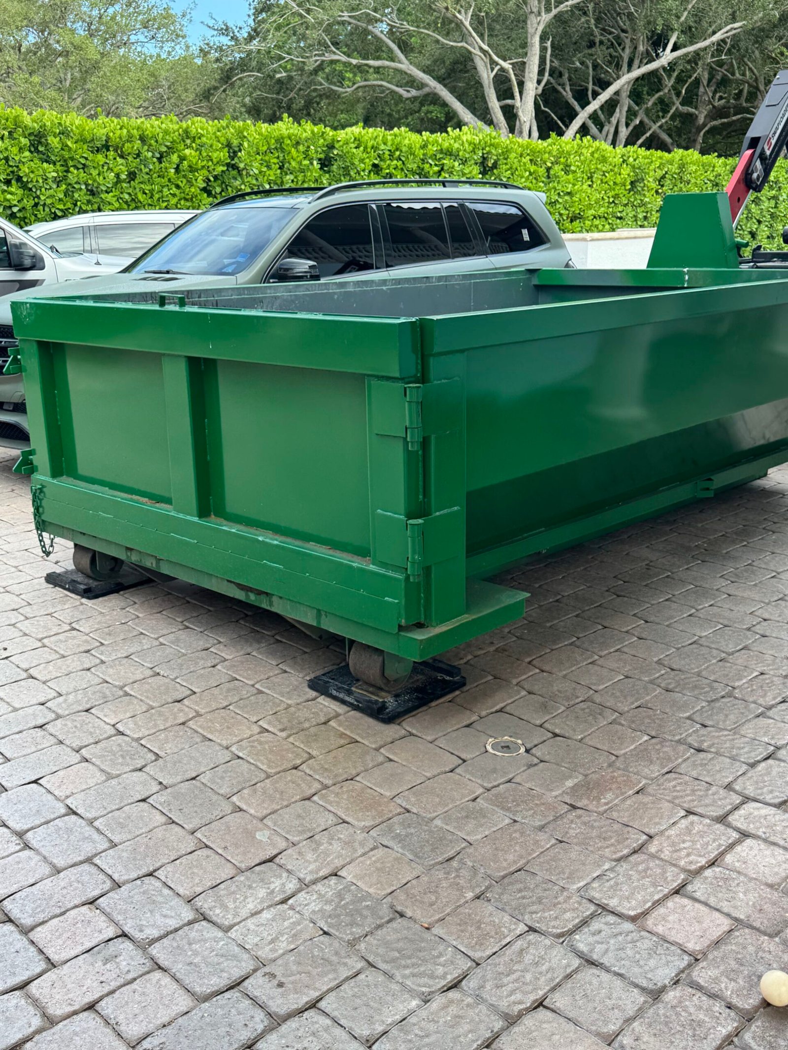Driveway protection boards under roll-off dumpster in Palm Beach County, FL