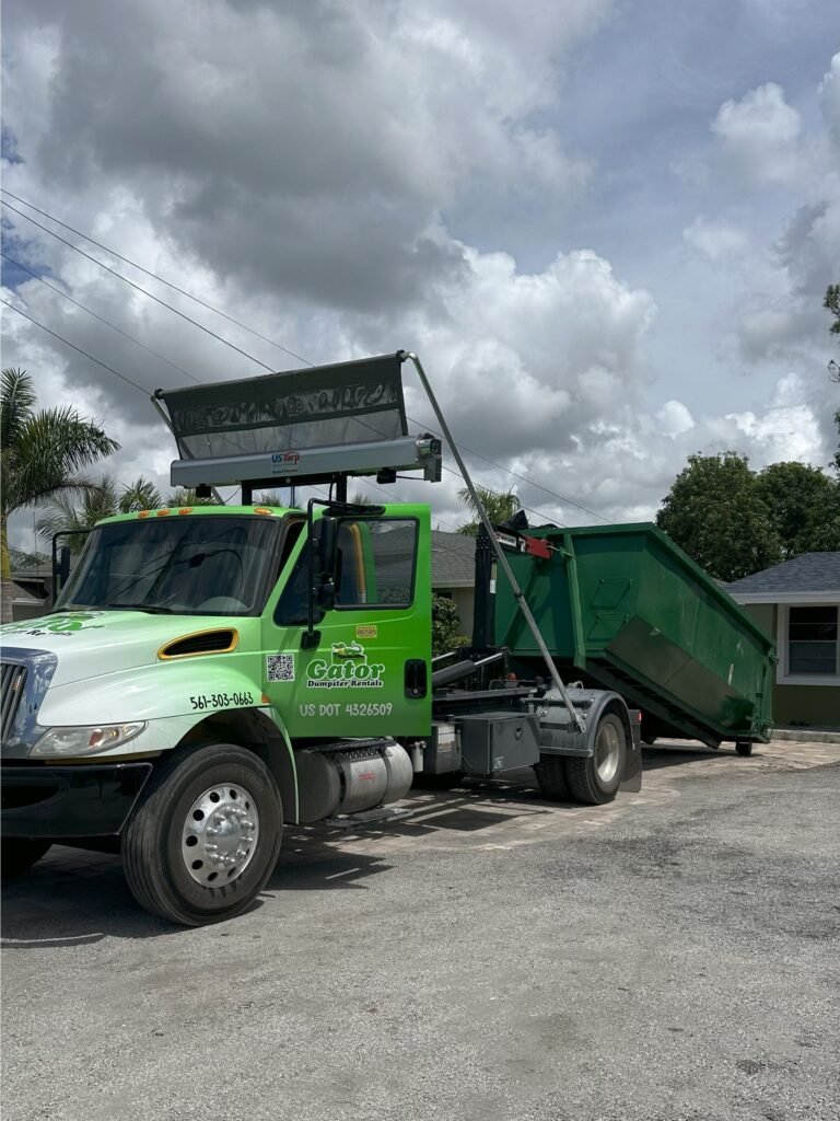 20-yard roll-off dumpster rental in West Palm Beach driveway, Same-day dumpster delivery in West Palm Beach FL, Residential dumpster rental for home renovation in West Palm Beach, Commercial roll-off dumpster on construction site in West Palm Beach, Dumpster with driveway protection boards in West Palm Beach, Gator Dumpster Rentals truck delivering roll-off in Palm Beach County, Contractor using 30-yard dumpster for demolition project in West Palm Beach
